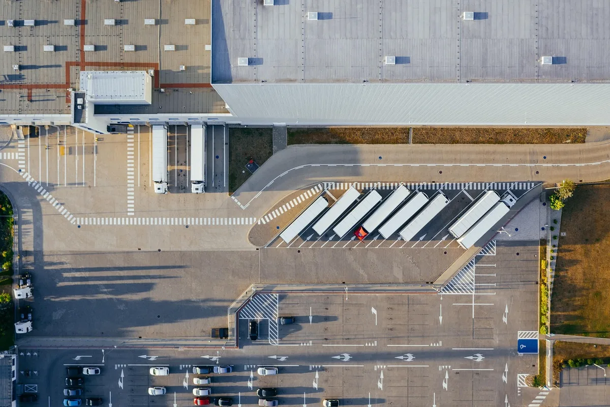 Camion électrique en dépôt près d'une borne de recharge