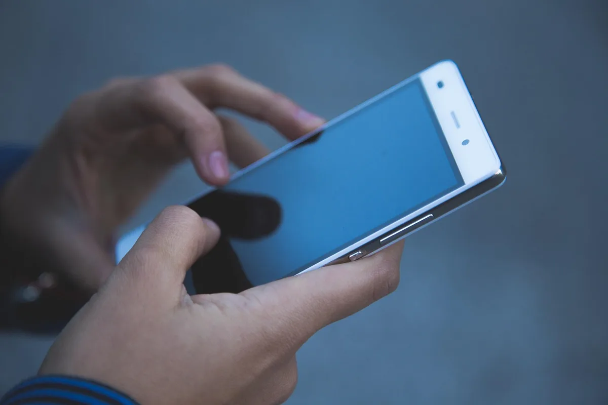 Main tenant un smartphone avec interface d'ordre d'achat vente ouverte